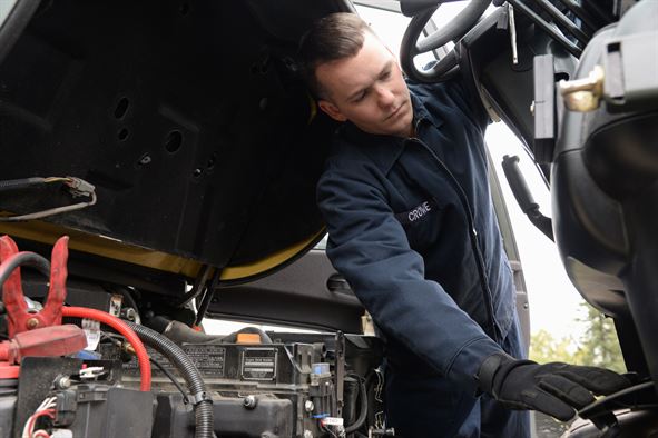 Engineer servicing a forklift truck