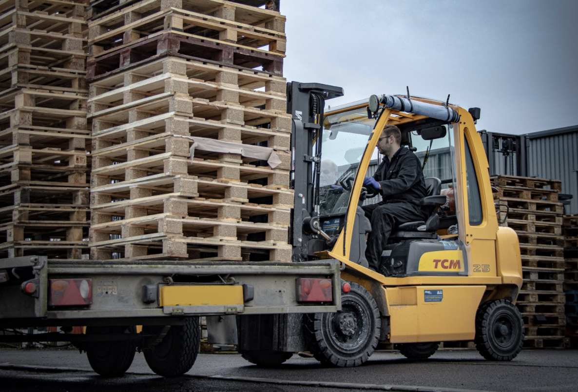 TCM forklift operator yellow pallet truck